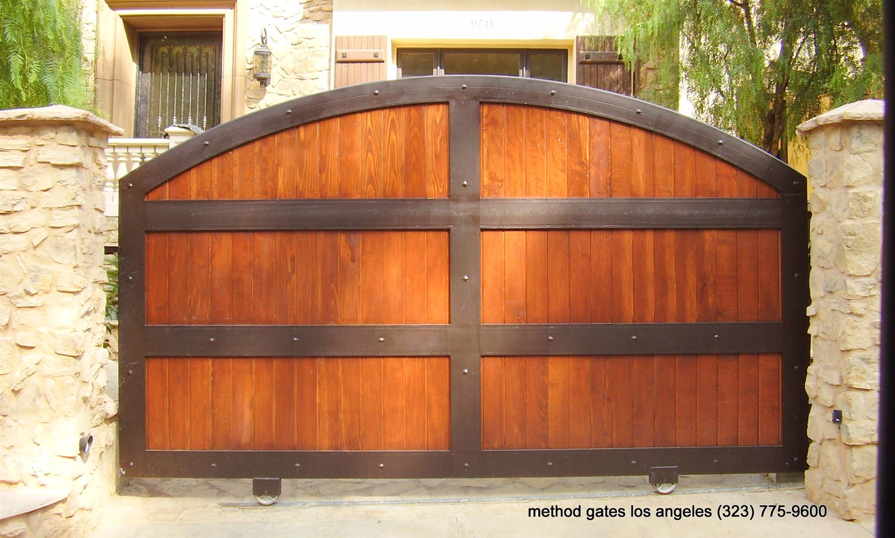 wooden automatic gate and concrete fence