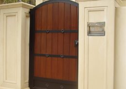 wooden entrance gate and concrete fence