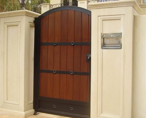 wooden entrance gate and concrete fence